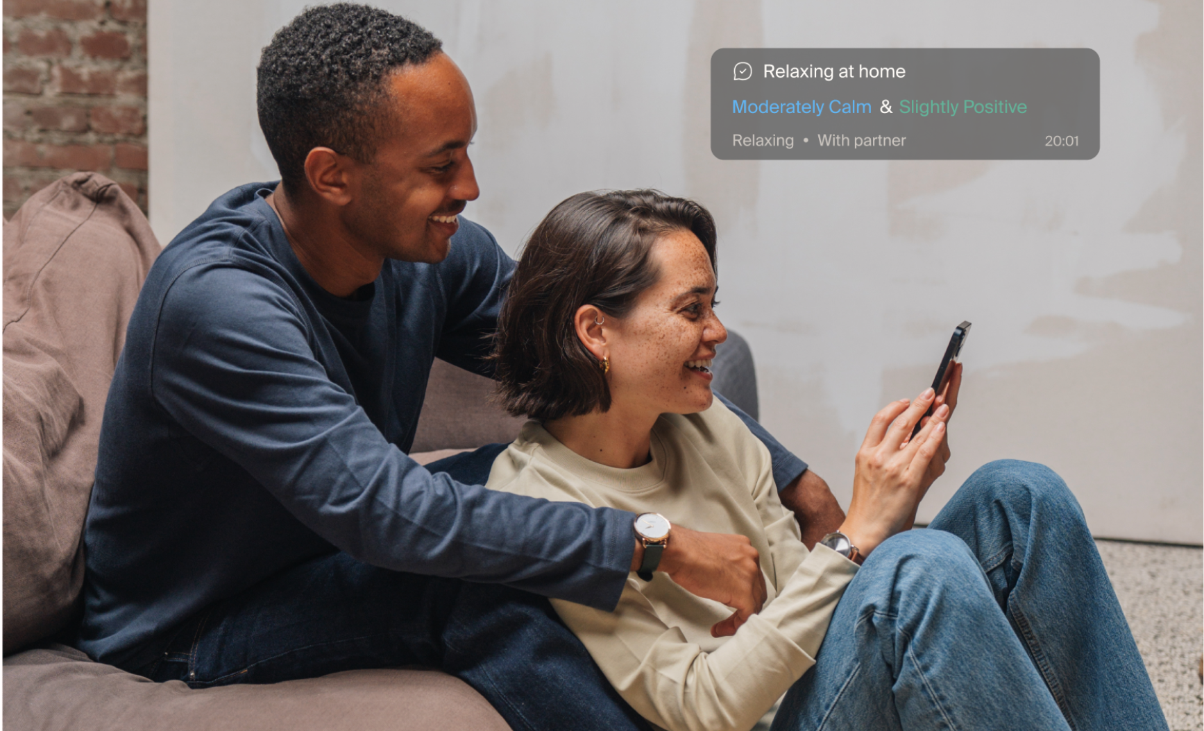 A smiling couple looking at a phone A smiling couple looking at a phone